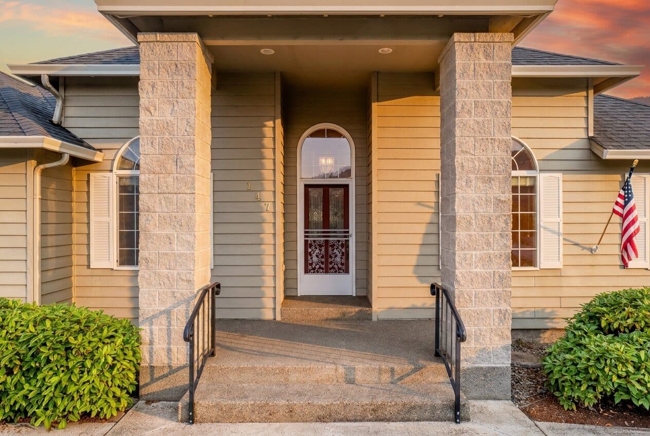 Covered front porch with stone columns — real estate photography by Hahn Media, Oregon