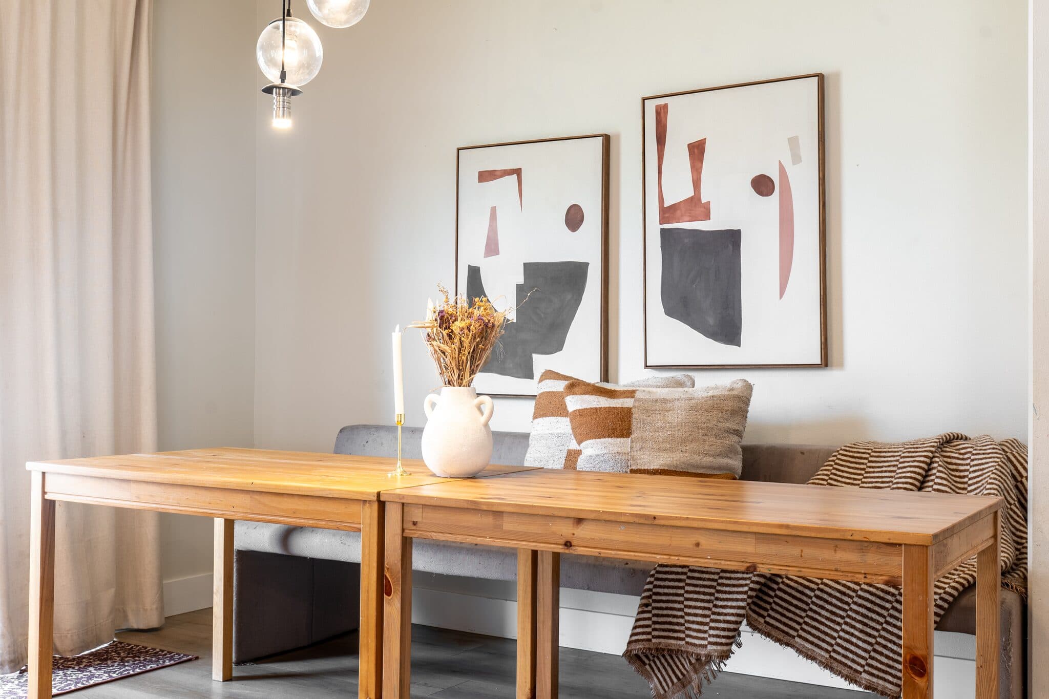 Dining nook with wood table and modern art — real estate photography by Hahn Media, Oregon